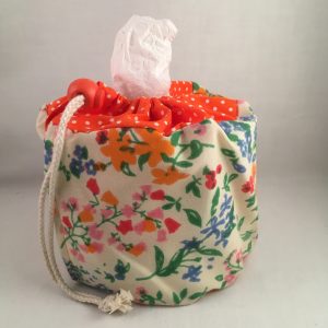 Toiletrolhouder voor camping of festival thema; retro bloemen print en oranje polkadot
